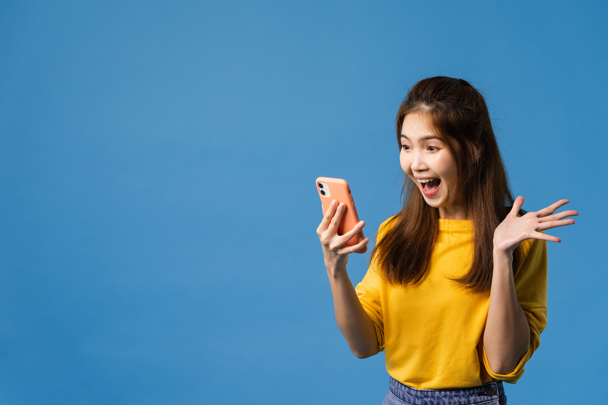 Surprised Young Lady Looking on Her Phone